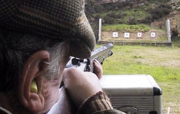 Shooter aiming at paper targets